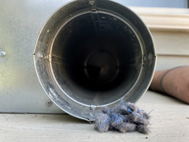 Torrington Dryer Vent Cleaning technician using specialized equipment to clear severe dryer vent blockage in Torrington